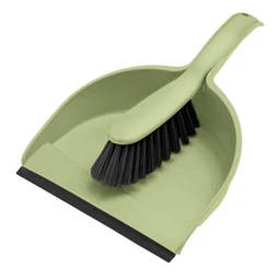 This is a green plastic dustpan with a matching small brush. It appears to be a compact cleaning set intended for general household use, likely suitable for quick swept-up messes in kitchens or bathrooms. The visible attributes include a light olive-green color, a wide, shallow dustpan lip, and a black-bristled broom head with a short handle, designed for easy sweeping and containment of debris.