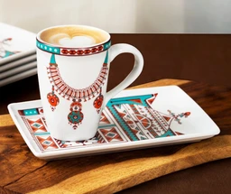 This is a ceramic mug paired with a decorative rectangular plate. The mug features a bold, colorful necklace-inspired pattern in turquoise, red, and teal tones, with a light latte visible inside. The accompanying plate has matching geometric and jewelry-inspired motifs, presenting a coordinating set likely aimed at adults, with a unisex, artsy boho style. The visible materials are glossy ceramic porcelain, with bright, saturated glaze colors and a white base.