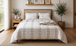 - What it is: A 3-piece double soft bed set (duvet cover and two pillow shams) shown on a neatly made bed.
- Audience: Unisex look based on neutral colors and bedding style; suitable for adults (men or women) who favor a light, minimalist bedroom aesthetic.
- Visible attributes: White and beige geometric patterned duvet cover with matching pillow shams, wooden bed frame and matching nightstands, neutral woven rug, indoor plants, and natural light giving a calm, cozy bedroom vibe. No brand names visible.
