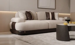 - Description: A modern, light-beige sectional sofa with a rounded, low-profile silhouette and dark brown base. It features multiple plush cushions in coordinating beige and brown tones, arranged with a mix of lighter and darker throw pillows.
- Intended audience: Unisex (suitable for men and women), based on its neutral color palette and contemporary living-room styling.
- Notable attributes: Fabric upholstery in light beige with dark brown leather-like base and trim; soft, rounded arms; decorative cushions with contrast stitching. Overall style is contemporary/cozy-luxe.