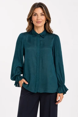 A satin button-up shirt with a glossy, smooth finish in teal. It features long sleeves with gathered cuffs and a classic collar, styled on a female model for a women’s audience. Notable details include the drapey silhouette, subtle sheen, and rich teal color.