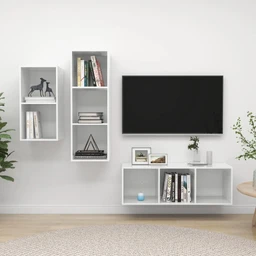 - Product: A three-piece wall-mounted shelf unit set (unitá أرفف - 3 قطع) shown in a modern living room setup.
- Audience & styling: Appears unisex, suitable for a contemporary home décor audience; white modular shelves mounted on a light wall, paired with a wall-mounted TV and a low cabinet beneath.
- Visible attributes: White rectangular open-shelf panels with vertical arrangement; materials look like wood or MDF with a smooth matte finish; shelves hold books, small decor items, and plants; overall style is minimalistic and clean with a light, airy feel.