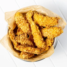 This image shows a bowl of crispy fried chicken strips, breaded with a golden, crunchy coating. The product appearsั่ง aimed at general/ family dining but could be marketed to a casual, shared meal audience (unisex). The visible attributes highlight a light brown to golden-yellow color, battered crust, and irregular, finger-length strips served in parchment-lined bowl. No brand names visible.