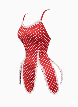 A one-piece swimsuit with a red base and white polka dots, featuring a halter-style top with thin straps. It has white lace trim along the neckline and side panels, giving a ruffled, decorative edge. Judging by the cut and styling, it appears intended for girls, with a playful, feminine look and a stretchy, fitted fabric likely used for swimwear.