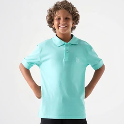 A basic mint green polo shirt with short sleeves made from cotton. It features a classic polo collar with a three-button placket and a small, subtle emblem on the left chest, suitable for boys given the child model and fit. Visible attributes include the light mint color, cotton fabric, short-sleeve styling, and a clean, simple polo silhouette.