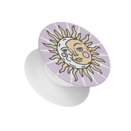 This is a Popsocket phone grip with a celestial sun and moon design on a light lavender background. The visible model is not gender-specific; styling reads as playful and artistic, suitable for a unisex audience. Notable attributes include a purple-lavender backdrop, a sun and moon illustration with gold and white tones, and a white, collapsible grip base.