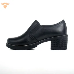 - What the product is: A black leather-looking slip-on loafer with a chunky block heel, labeled as an “Elastic 5-Cm Shoe.”
- Intended audience: Women (judging by the mid-height heel and styling).
- Notable attributes (visible): Black smooth leather upper, stitch detailing along the welt, elastic side panel for easy slip-on, 5 cm stacked block heel with a textured, perforated pattern, and a slightly rounded toe.