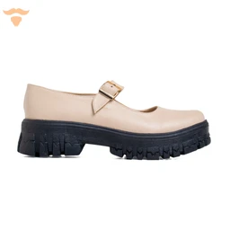 This is a single beige Mary Jane style shoe with a chunky black lug sole and a strap with a buckle across the instep. The visible styling suggests a unisex or women's fashion shoe, intended for casual or fashion-forward wear. Notable attributes include the smooth beige leather upper, a pronounced platform-like tread on a thick black sole, and a small decorative buckle.