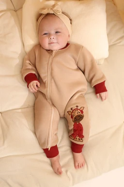 - What the product is: A baby sleepsuit onesie in a warm, full-body design with zipper closure. It features a soft, fleece-like material and ribbed cuffs.
- Apparent audience: Infants/kids (unisex, but styling leans toward a baby girl due to the headband and soft pink/beige tones).
- Notable attributes: Beige/tawn color with red rib cuffs, embroidered reindeer motif on one leg, and a matching headband bow; full-body coverage for warmth and comfort.