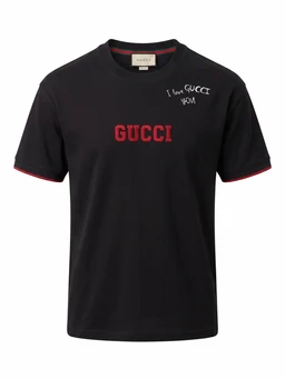 - Product: Black short-sleeve T-shirt with red Gucci-inspired branding. 
- Audience: Unisex or men’s sizing inferred from cut and styling; model appears male.
- Visible attributes: Black cotton knit tee with red stitched “GUCCI” text on the chest and small white “I love GUCCI UOM” style script at the left shoulder area, red piping at sleeve hems, crew neckline, standard fit. No branding or labels beyond the shown text; no other patterns or graphics.