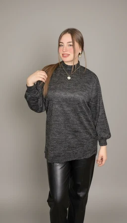 - Product: Black leather-look pants (بنطلون جلد أسود) styled for a casual, chic look.
- Audience and styling cues: Appears to target women, with a relaxed-fit dark gray knit sweater and black shiny faux leather pants, paired with a simple necklace and hoop earrings for a modern, urban vibe.
- Visible materials and attributes: Glossy black material resembling leather (likely faux leather) for the pants; the top is a dark gray knit fabric with a loose, drop-shoulder fit; overall color palette is monochrome (black and dark gray) with a sleek, fitted look on the legs and a looser top.