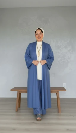 - Description: A woman wearing a light blue, airy kimono-style outer garment over a white underlayer and white headscarf. The long, wide-sleeved robe falls to the ankles, with a loose, flowing silhouette.
- Intended audience: Unisex-looking modest fashion; appears suitable for women based on styling and fit.
- Notable attributes: Material appears lightweight and linen-like with a soft texture; solid light blue color; open-front kimono design with wide sleeves and a long, draped silhouette; paired with a white inner top and headscarf.