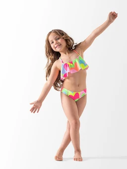 - What the product is: A two-piece swimsuit set with a ruffled, halter-neck top and matching bikini bottoms.
- Apparent audience: Girls (child) based on the child model and sizing.
- Notable attributes: Bright, multicolor pattern with neon pink and lime green accents; ruffled bandeau/halter top and side-tie bikini bottoms with a tropical-abstract print. Material appears to be typical swim fabric with a smooth, stretchy finish.