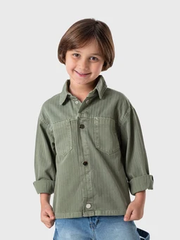 A lightweight utility jacket in olive green with a casual, oversized fit suitable for boys. It features a button-front closure, a collared neckline, and a single chest pocket with visible stitching; sleeves are rolled up to wrist length. The material appears to be a soft cotton-corduroy or brushed cotton, giving a matte, rugged texture and a relaxed style.