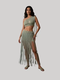 What the product is: A two-piece performance/clubwear outfit featuring a one-shoulder cropped top and a matching fringe skirt with long tassels.
Intended audience: Women's.
Notable attributes: Olive green color, macramé-style knit with fringe detailing; asymmetric one-shoulder top with a banded hem, high-waisted skirt with long fringe that creates a dramatic drape and a high slit, and flat sandals as styling. Visible fabric appears to be lightweight knit with decorative fringe for a festival or performance look.