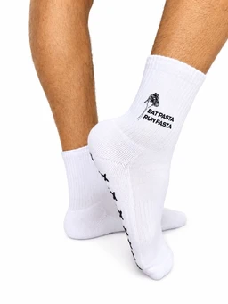 - What it is: A pair of white crew socks with a small black graphic and text on the side of the ankle.
- Audience and styling cues: Appears designed for men (model’s legs shown) with a casual athletic vibe suitable for everyday wear or sports.
- Notable attributes: White fabric, ribbed cuffs, mid-calf length, graphic print featuring a small bicycle icon and the words “EAT PASTA RUN FAST” in black; black detailing runs along the sole. Material looks soft knit. No brand name visible.