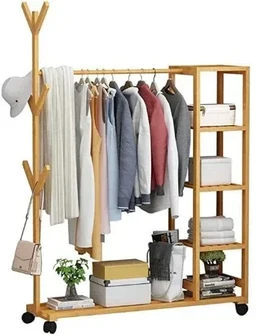 - A wooden clothes rack with an integrated shelf and hanging rod, displaying a variety of coats, shirts, and jackets. It appears to be unisex or suitable for adults; the visible sizing and arrangement suggest a wardrobe storage/display unit rather than a traditional wardrobe.
- Notable attributes: light natural wood finish, multiple hanging spaces with a central rail, side shelving with fabric bins and boxes, small wheels for mobility, and a decorative hat and bag accessory visible. The product is intended for organizing and drying clothes, with a simple, minimalist, Scandinavian-inspired style.