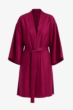 This is a belted open-front cardigan in a rich magenta/red color. It appears designed for women, featuring a loose, kimono-inspired silhouette with wide three-quarter sleeves and a matching fabric belt at the waist. The material looks soft and drapey, likely a knit or fleece-like fabric with a smooth matte finish.
