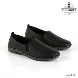 - What the product is: A pair of black slip-on casual shoes with a textured leather-like upper and stitched sole.
- Apparent audience: Unisex or general adult, based on the neutral design and sizing cues.
- Notable attributes visible: Matte black pebbled surface, elastic side panels for easy slip-on, rounded toe, low-profile stitched outsole in dark brown/black, and a small pull tab at the heel. Overall style is simple, casual, and comfortable.