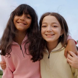 - What the product is: A knit pullover with a half-zip collar, shown in a casual, sporty knit style.
- Apparent audience: Unisex (model styling and fit suggest suitability for both men and women or youths; the photo shows two girls wearing it).
- Notable attributes visible: Oatmeal/beige knit fabric with a zip neckline; soft, medium-weight sweater texture; ribbed collar and cuffs; clean, simple design without visible branding. The photo features two girls smiling, each wearing the sweater in a light pink and a light beige color.