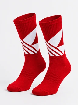 - A pair of mid-calf athletic socks in bright red with white geometric stripe accents on the leg portion.
- Intended audience: unisex (based on neutral styling and sizing cues, though modeled as but no gender-specific features evident).
- Notable attributes: bold red color, white angular stripe design, ribbed cuff, constructed ankle and heel shaping, and a sporty, crew-length sock style.