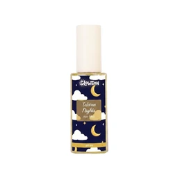 This is a small bottle of Warm Nights Hair Mist with a white cap and a dark blue label featuring white clouds and gold crescent moons, giving a dreamy night-sky aesthetic. It appears targeted toward adults (unisex styling cues are minimal, but the product presentation leans neutral to female-leaning). Notable attributes visible: clear glass bottle, white spray cap, gold-tone label accents, and a night-sky motif on the label.