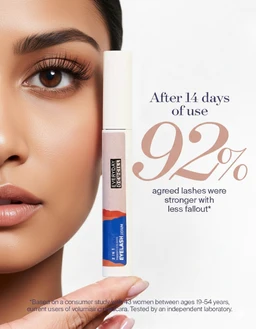 - What it is: A close-up product photo showing a tube of eye lash serum held near a model’s eye, with part of the model’s face visible for lash emphasis.
- Audience and style cues: Appears aimed at adults (likely women) given the feminine makeup and lash focus; packaging is slender and feminine with a white cap and clear/blue label.
- Visible materials and attributes: The product tube features a light pink body with a white cap and a blue label at the bottom; bold typography on the right advertises “After 14 days of use 92% agreed lashes were stronger with less fall out.” The model has long, well-defined lashes; the overall styling is clean and clinical, suggesting a cosmetic serum.