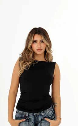 A sleeveless, form-fitting top in solid black. The model appears female, wearing a high, one-shoulder neckline with a clean, minimalist cut. The fabric looks smooth and slightly stretchy; the top is paired with casual denim jeans, giving a chic, versatile look. Notable attributes: black color, sleeveless, one-shoulder/crew-like neckline, fitted silhouette, basic solid style.