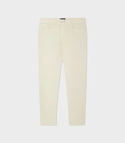 - A pair of light-colored, slim-fit trousers with a clean front and classic five-pocket styling, shown against a neutral background.
- Intended audience: men's, judged from the cut and styling.
- Notable attributes: pale cream/off-white hue, slim fit from the waistband through the leg, standard belt loops, zip fly with button closure, and minimal detailing. The fabric appears smooth, likely a cotton blend suitable for smart-casual wear.
