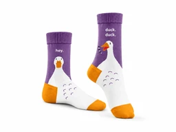 - Product: A pair of colorful socks featuring a cartoon duck design. The socks are purple with orange toes and heels, and a white duck graphic extending from the ankle to the foot. One sock shows the duck’s face and “hey.” text near the cuff; the other shows a duck body with small, black wing details.
- Intended audience: Unisex or kids’ sizing appears suitable for children or playful adult wear, based on the whimsical cartoon design and bright colors.
- Visible materials and style: The socks appear to be knit fabric with ribbed cuffs, solid purple body, orange toe/heel accents, and a white duck motif. Bright, graphic, playful style.