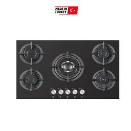 - Description: A black glass gas cooktop with five burners arranged on a rectangular surface. The central burner is larger, with two medium burners on the sides and two smaller corner burners. Five control knobs at the front suggest individual flame control for each burner, with markings underneath each knob.
- Intended audience: Unisex (appears suitable for both men and women who use built-in kitchen appliances).
- Notable attributes: Black glass top, stainless steel burner rings, five burners including a central high-power burner; compact, built-in style. The photo indicates a Made in Turkey label.