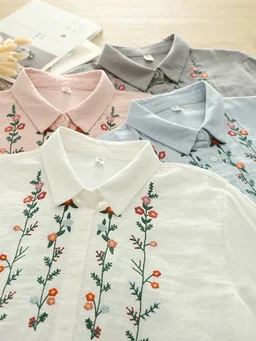 - What the product is: A set of collared embroidered shirts in soft, lightweight fabric, shown laid flat in various pastel colors.
- Apparent audience: Women or unisex adult sizing, based on delicate floral embroidery and pastel tones.
- Notable attributes: Light, breathable material with vertical floral embroidery in orange and green thread; pastel colors including white, pink, gray, light blue; classic polo/collared shirt style with button placket.