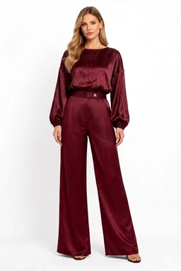- What the product is: A matching satin pajama set (Blouse and wide-leg pants) in a cohesive burgundy satin finish.
- Intended audience: Women's (model styled in a feminine blouse with voluminous sleeves and high-waisted wide-leg pants).
- Notable attributes: Rich burgundy satin fabric with a glossy sheen, long puff sleeves, relaxed loose-fitting top, high-rise wide-leg pants, full-length silhouette.
