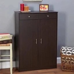 - Product: A dark wood-finish cabinet with a pair of doors and two small top drawers. It appears to be a MDF wooden storage cabinet offering enclosed storage.
- Intended audience: Unisex (suitable for adults entering a home); styling is simple and modern.
- Visible features: Rich dark brown/espresso color, vertical cabinet doors with slim metal handles, two small top drawers with round knobs, compact rectangular shape, sits against a light gray wall; top surface shows a few decor items (candles, small framed photo) and a small basket nearby. Material texture suggests wood veneer or laminate over MDF; overall dimensions indicated by title as 80*35*110 cm.