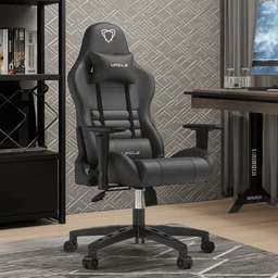 - Description: A black gaming chair with a high back, integrated headrest and lumbar support, mounted on a five-wheel base. It features armrests, a tilt mechanism, and a gas lift for height adjustment, shown in a home office setting.
- Intended audience and visible attributes: Unisex (designed for men and women) judging from the ergonomic racing-style cut and proportions. Notable visible materials and colors: black synthetic leather upholstery with contrast stitching, a padded headrest and lumbar pillow, and a sturdy plastic/metal frame with a chrome gas lift. Overall style: modern gaming/office chair with a sporty, race-seat appearance.