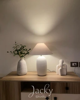 - What the product is: A bridle bundle set, displayed on a wooden console with decorative items.
- Intended audience: Appears unisex, suitable for a shared living or home décor context.
- Notable attributes visible: A soft, neutral color palette with a textured ceramic lamp and two ceramic vases/figurines. The styling is minimalist and modern, with natural wood tones and a subtle, ambient light. No branding visible.