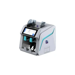 - What the product is: An electronic banknote counting machine with a touchscreen display and dual currency slots, designed for counting and validating bills.
- Intended audience: Unisex; looks like a compact desktop device suitable for small offices or retail use.
- Notable attributes: Light gray exterior with teal/blue accents, a color touchscreen control panel, two top-feeding hoppers, and a front output/receipt area. Material appears to be hard plastic with a modern, rectangular shape.