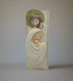 - What the product is: A vertical religious statue depicting the Holy Family (Joseph, Mary, and Baby Jesus) with a carved, three-dimensional relief look. 
- Apparent audience: Unisex; suitable for households or religious display, likely appealing to collectors.
- Notable attributes: Cream/ivory-toned resin or ceramic material with softly colored wraps; Mary and Baby Jesus wrapped in flowing white/cream garments, Joseph with a halo above, all arranged in a compact standing composition. The overall style is sacred-figurine with gentle, devotional imagery.