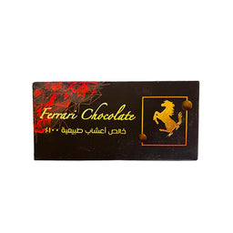 - What the product is: A rectangular dark chocolate bar packaging labeled “Ferrari Chocolate” with a gold horse logo on a red-and-gold accented box.
- Intended audience: Unisex (image shows a generic chocolate bar; no gender-specific styling).
- Notable attributes visible: dark chocolate color with gold and red foil/printing, Arabic script, and a gold Ferrari-style horse emblem on a square frame. The packaging is black with red accents and a glossy finish.