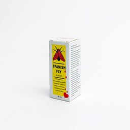 This is a small boxed bottle labeled Spanish Fly (قطرات سبانش فلاي الأصلية), likely a dietary or topical product. The packaging features a bright yellow panel with a red flying insect image and red drops, suggesting a bold, attention-grabbing design aimed at adults. The box appears compact (15 ml) and primarily uses white with yellow and red accents, conveying a compact, bottle-friendly presentation.