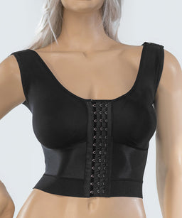 - What the product is: A black corrective/stride-style cropped bustier top with a wide front hook-and-eye panel, designed to shape and support the torso.
- Apparent audience: Women (adult female) judging from the fitted silhouette, cups, and styling.
- Notable attributes: Matte black fabric with a wide elastic underbust band, a front vertical panel featuring multiple hook-and-eye closures, square neckline, wide shoulder straps, and a snug cropped length that ends just below the bust. The garment appears seamless and smooth with a molded cup shape.