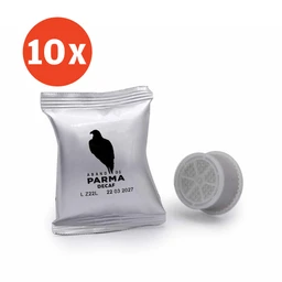 A small, single-serve coffee capsule pouch and a loose, matching capsule cap placed beside it. The packaging is silver with a black bird silhouette and text, suggesting a decaf blend. The image also features a bold red “10x” circle in the top-left, indicating a multipack. Intended for adult coffee drinkers (unisex appearance) with a metallic, minimalist, and compact capsule style. Notable attributes: decaf, Lavazza-compatible style, silver foil packaging, circular capsule lid.