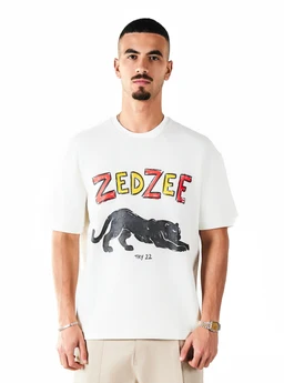 A white short-sleeve T-shirt featuring a graphic print of a reclining black panther and the word “ZEDZEE” in colorful block letters across the chest, with a small “TRY 22” text beneath. The fit appears relaxed on a male model, suggesting a unisex or men’s sizing style; styling is casual and graphic-forward. Notable attributes: cotton knit, crew neck, bold multicolor typography, and a monochrome black panther graphic.