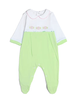 - What it is: A baby/infant long-sleeve playsuit with a white top and pale lime-green bottom, styled as a one-piece romper.
- Audience and styling cues: Appears designed for girls (soft pastel colors, delicate embroidery, and rose-themed details) with a vintage-inspired collar and decorative border stitching.
- Visible materials and attributes: Light-weight knit or cotton fabric in white and mint-green, long sleeves with lime-green cuffs, a Peter Pan-style collar with pink stitching, rose-embroidered trim at the midsection, and snap/button closure at the crotch for easy wearing. The lower portion features gathered ankle cuffs and front pleats for a relaxed, romper silhouette. No visible branding.