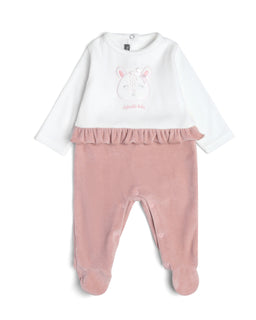 A two-tone baby romper featuring a white top with a bunny face graphic and long sleeves, paired with dusty pink lower half and built-in feet. The design suggests a infants’ or very young toddlers’ outfit, likely for girls, with a pink ruffle seam at the waistline adding a feminine touch and soft plush-like fabric. Notable materials visible include the soft-knit fabric in white and pink, with a cozy, velvety finish and pastel color palette.