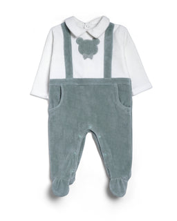 A baby’s: a long-sleeve white top paired with light blue/grey corduroy-style overalls with footed bottoms. Intended for infants (unisex-leaning toward boys or neutral), as suggested by the pastel shade and cute bear motif on the chest. Notable details include the bear head applique at the front, shoulder straps, front pockets, and soft, plush-looking material with a gentle, pastel blue-gray color.