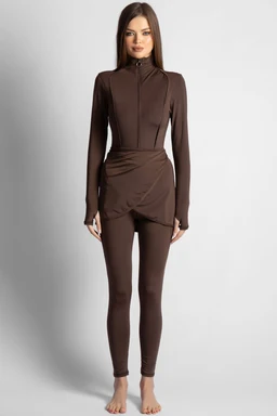 - What it is: A chocolate-brown wrap-set (long-sleeve top with matching leggings and a front-witted wrap detail) shown on a female model.
- Intended audience: Women's active/casual wear, from the styling and fit of a fitted top and high-waisted leggings.
- Notable attributes: Matte chocolate color, full-coverage long sleeves, zip or wrap-front detail creating a wrap silhouette, slim-fit leggings, ankle-length. The fabric appears smooth and stretchable, suitable for athleisure or loungewear.