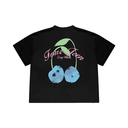 A black short-sleeve T-shirt featuring a large cherry graphic on the back or center with green stems and two blue-tinted cherries. The design includes pink script text that reads “Tour” or similar, giving a retro, playful vibe. The visible styling suggests a unisex cut with a relaxed fit suitable for casual wear; material appears to be cotton jersey.