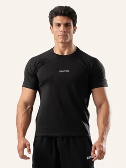 - What it is: A black fitted T-shirt (slim cut) modeled on a male figure.
- Intended audience: Men's or unisex-fitted casual wear, shown on a male model.
- Notable attributes: Short sleeves, crew neck, solid black color, minimal branding with a small white text logo at the center chest, smooth stretchy fabric suggesting a slim, athletic fit.