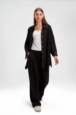- What the product is: A full outfit set in black, featuring a long-sleeve button-front jacket and matching wide-leg pants, styled together as a coordinated look.
- Intended audience: Women (based on the model and styling).
- Notable attributes: The set appears to be made of lightweight linen with a matte finish; the jacket has a relaxed fit with a button closure and side pockets, while the pants are high-waisted with a loose, wide-leg silhouette. The look is completed with a white top underneath and casual light-colored footwear.